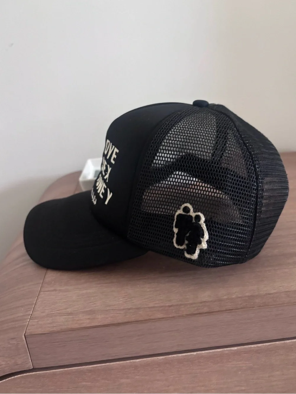 Black Trucker hat with White Embroidery. Homme + Femme “fake love”